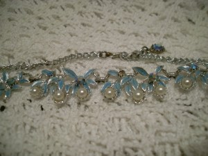 Silver tone. Soft blue leaves. White pearl beads. Aurora beads inset. Hook clasp.